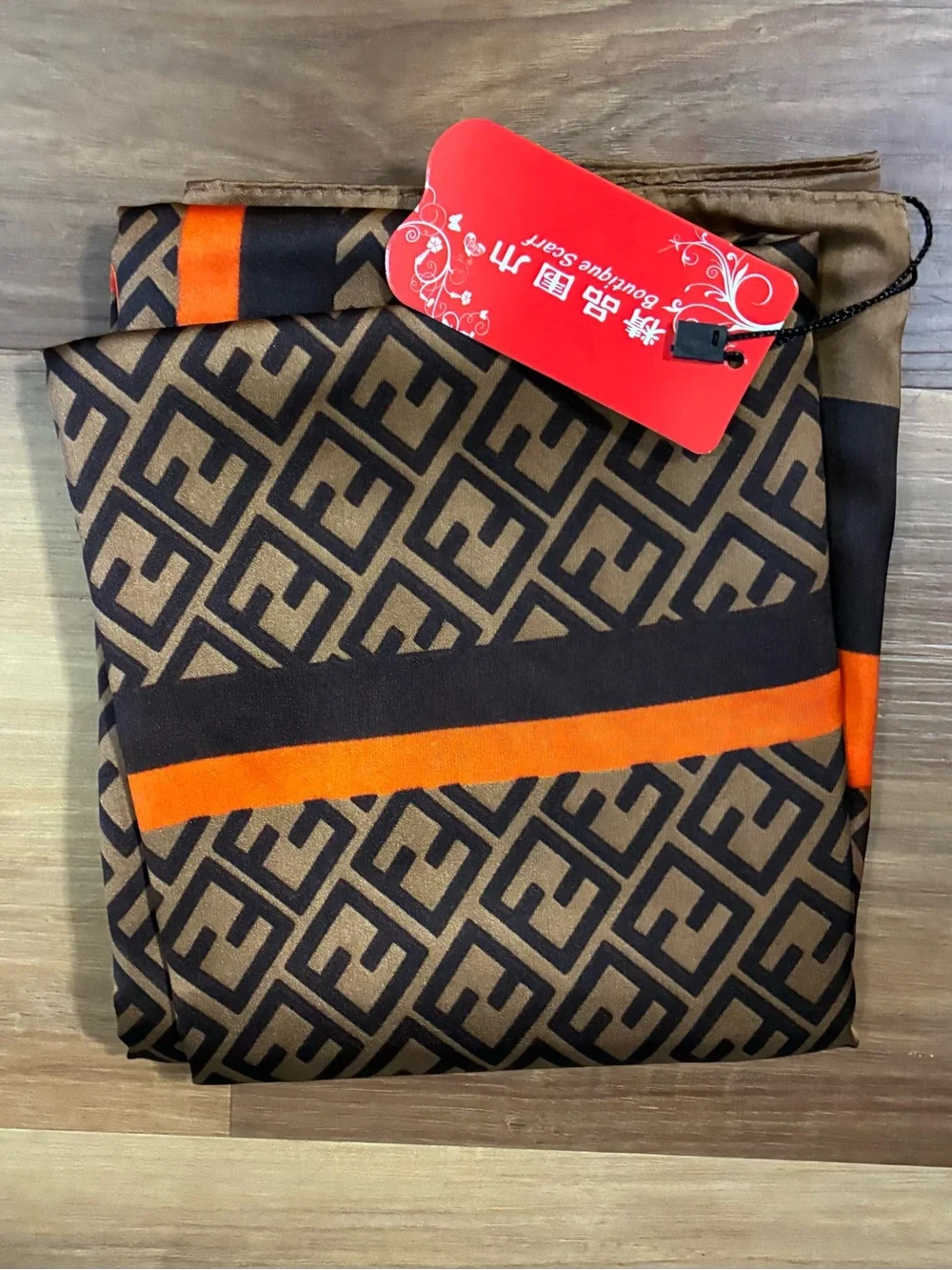 NWT brown and orange & tan geometric scarf. Polyester w/Silk feel. Approx 70 in